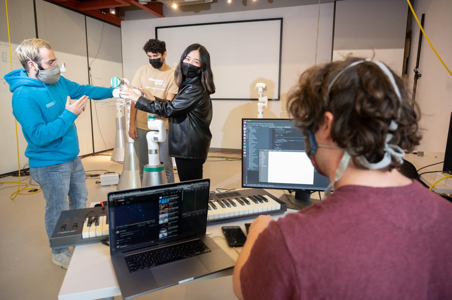 Georgia Tech Music Technology graduate student Amit Rogel (foreground, right) consults with other FOREST project researchers (L to R) Mohammad Jafari, Michael Verma and Rose Sun. (Photo credit: Allison Carter, Georgia Tech)