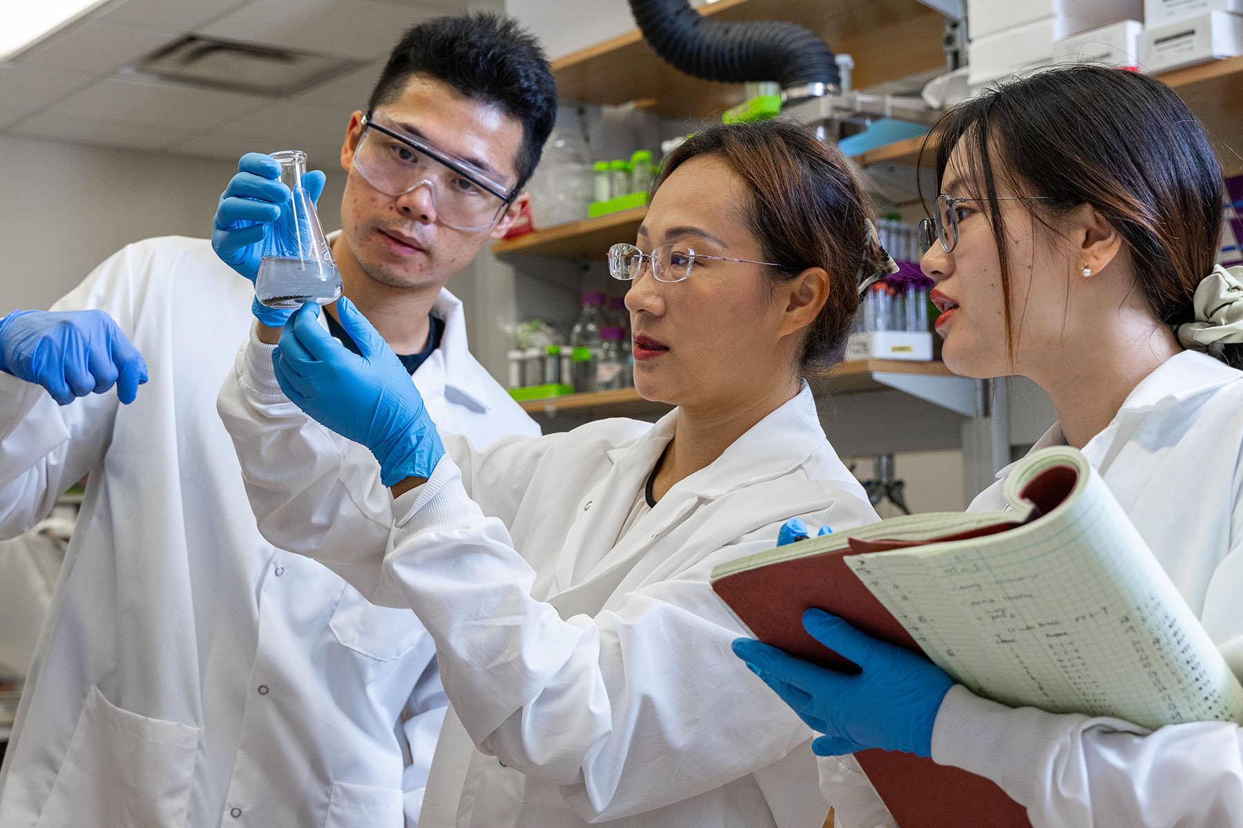 ang, post-doctoral researcher Yinghao Wen, and Ph.D. student Hang Xu check out the reaction for recovering rare earth elements from combustion residue.