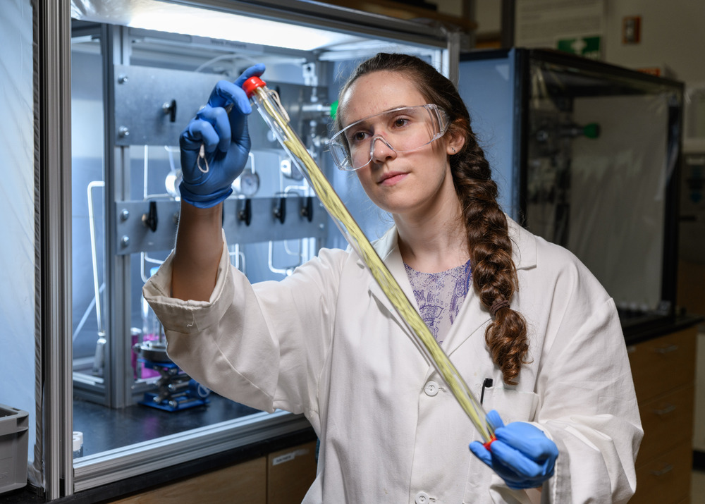 Georgia Tech grad student holding a hollow fiber membrane that can be used for low-energy chemical separation.