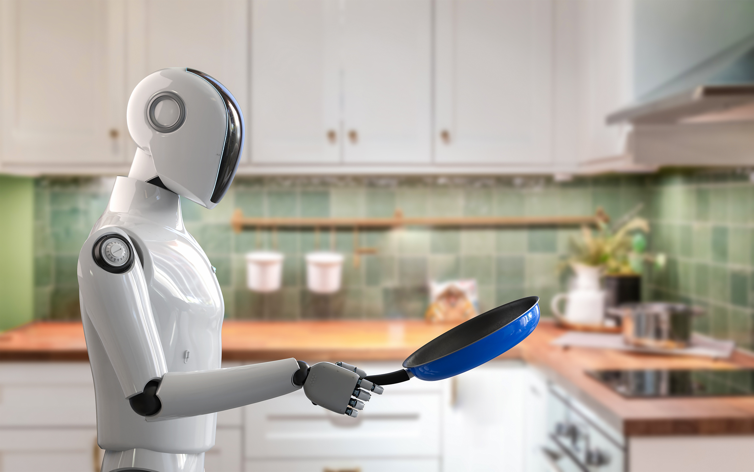A white humanoid robot holds a blue pan while standing in a kitchen with a green backsplash