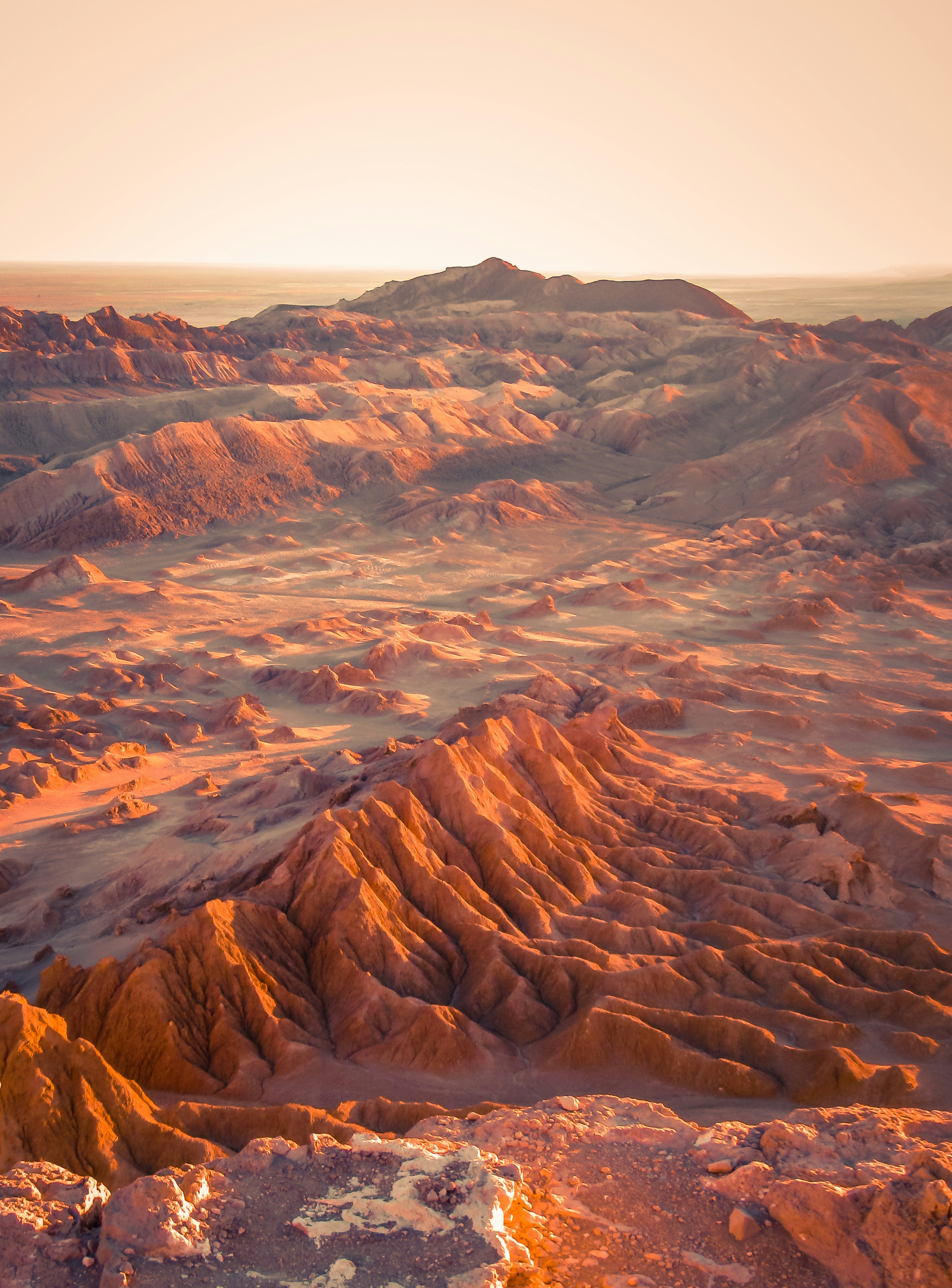 A landscape of red mountains and valleys in the arid Atacama Desert.
