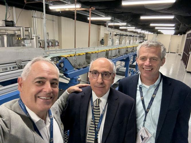 Ángel Cabrera, Cyrus Aidun, and Tim Lieuwen pose for a selfie in front of the equipment of the new Multiphase Forming Lab.
