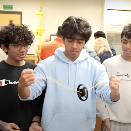Students demonstrating an application of frugal science.