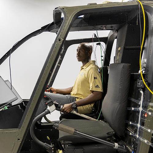 Richard Agbeyibor, flight test engineer, U.S. Air Force, sitting in a space exploration simulator.