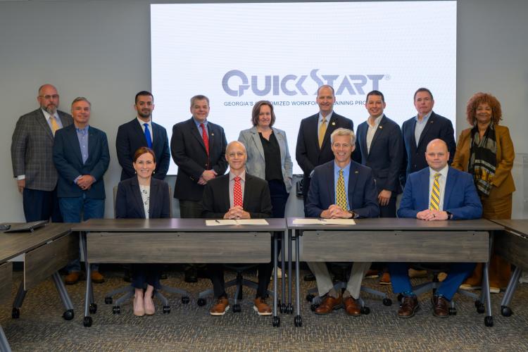 Georgia Quick Start Deputy Commissioner Scott McMurray (center left) and Georgia Tech Executive Vice President for Research Tim Lieuwen (center right) gathered with members of the Georgia Tech Manufacturing Institute, Georgia AIM, and more to officially commemorate the partnership on April 8.