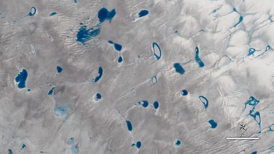 A view of Greenland's ice sheet from the NASA/USGS Landsat 8 satellite showing meltwater lakes on a glacier. (Credit: NASA)