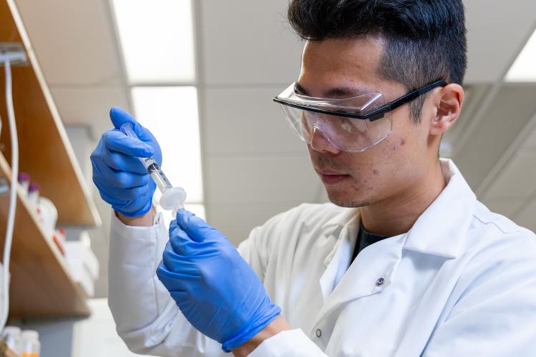 Student in the lab working with a sample