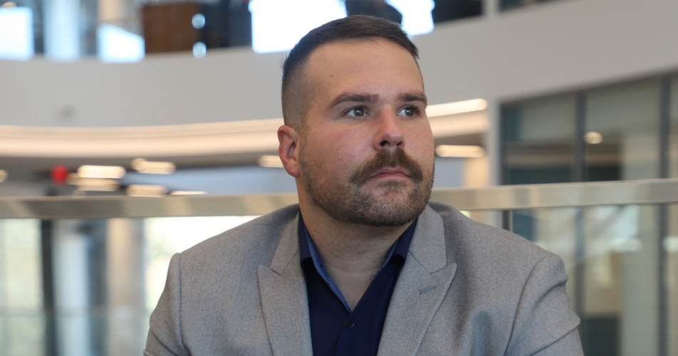 Adam-MacCallum,Jim Pope Fellow and translational research advocate in Georgia Tech’s Wallace H. Coulter Department of Biomedical Engineering, sits pensively, looking out.