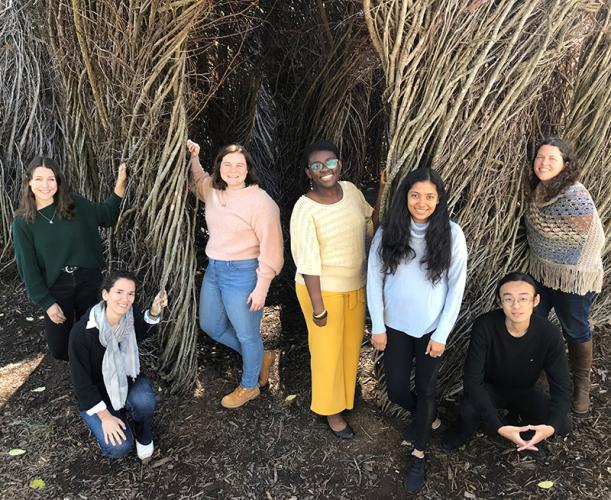 Group photo of the first class of BBISS GRA Scholars in front of the EcoCommons Patrick Dougherty Sculpture installation. They are Katherine Duchesneau, Ioanna Maria Spyrou, Meaghan McSorley, Bettina Arkhurst, Udita Ringania, Yilun 'Elon' Zha, and Marjorie Hall.