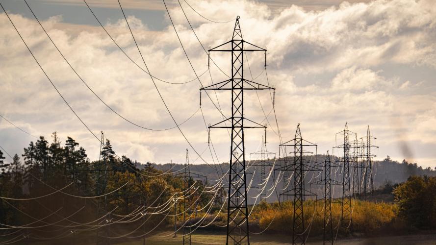 Power lines running through open land.