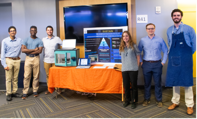Team Sustain poses with their lock box for home cooked meals at the 2024 Spring Capstone Expo.