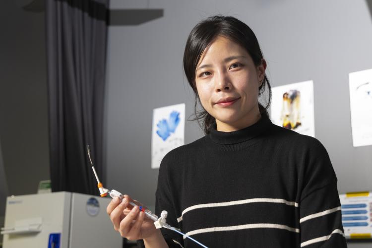 Female researcher in Hong Yeo's lab holding a nanosensor