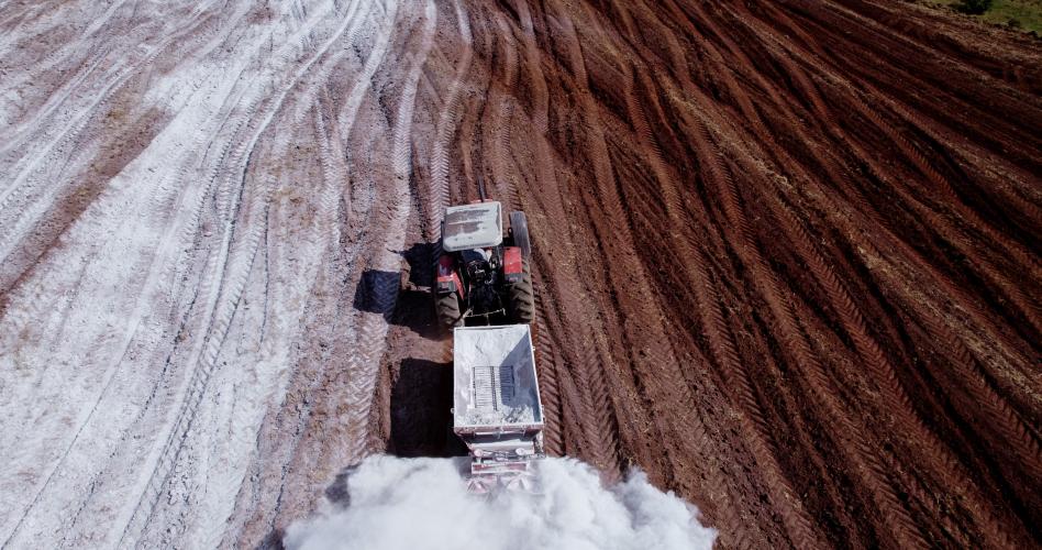 A tractor applying lime