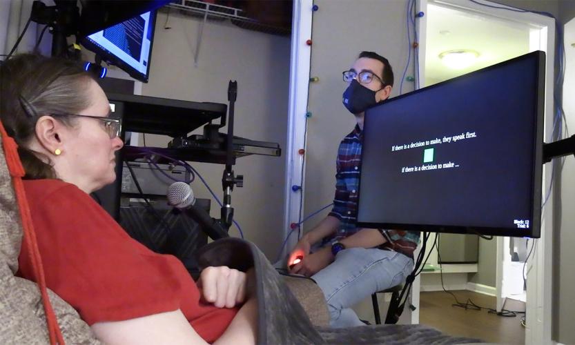 During a research session, a participant looks at a monitor and imagines saying the text cue displayed on screen. Text below the cue shows the brain-computer interface’s prediction of her imagined words.