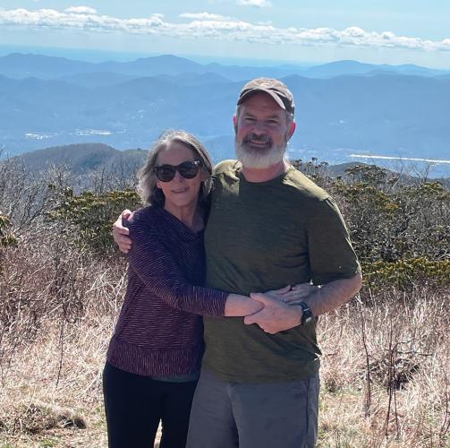 Rebecca Watts Hull and her husband Jonathan pose at a scenic overlook on a hiking trip.