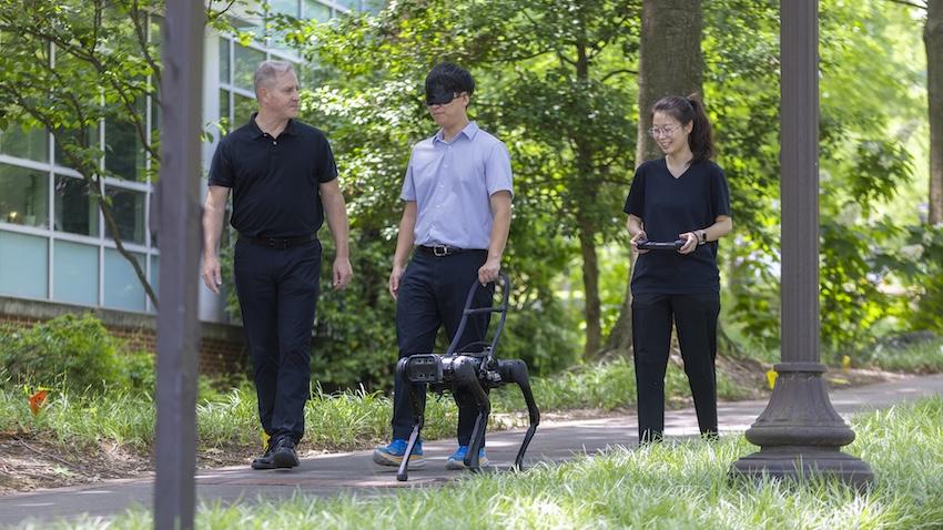 Georgia Tech researchers test their prototype of a robotic guide dog. Photo by Terence Rushin/College of Computing.