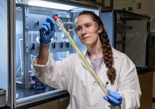 Georgia Tech grad student holding a hollow fiber membrane that can be used for low-energy chemical separation.