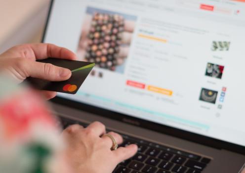 Stock photo of person shopping online with a credit card