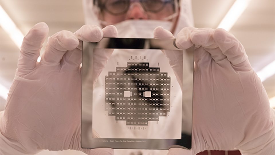 IEN cleanroom staff member holding a wafer