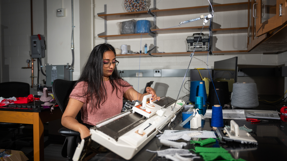 Krishma Singal operates knitting machine