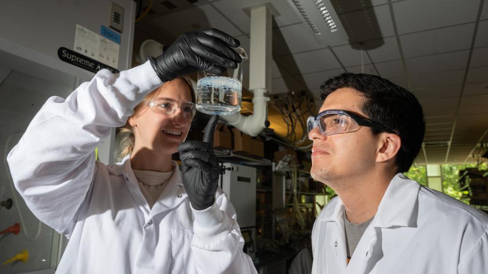 Erik Barbosa and Madeline Morrell examine salt beads