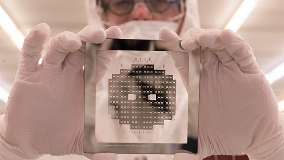 Cleanroom worker holding a wafer