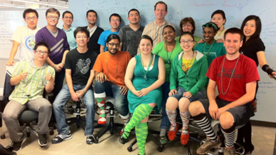 Group photo of BBISS students and staff wearing St. Patrick's Day regalia, mostly goofy socks.