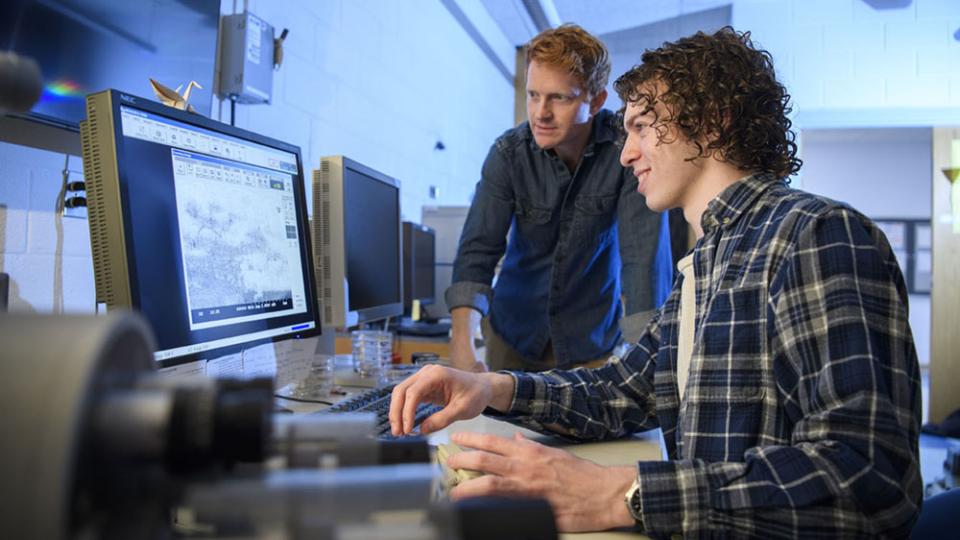 Berry College student Jacob Sylvie and his advisor Zack Lindsey working at a materials imaging tool
