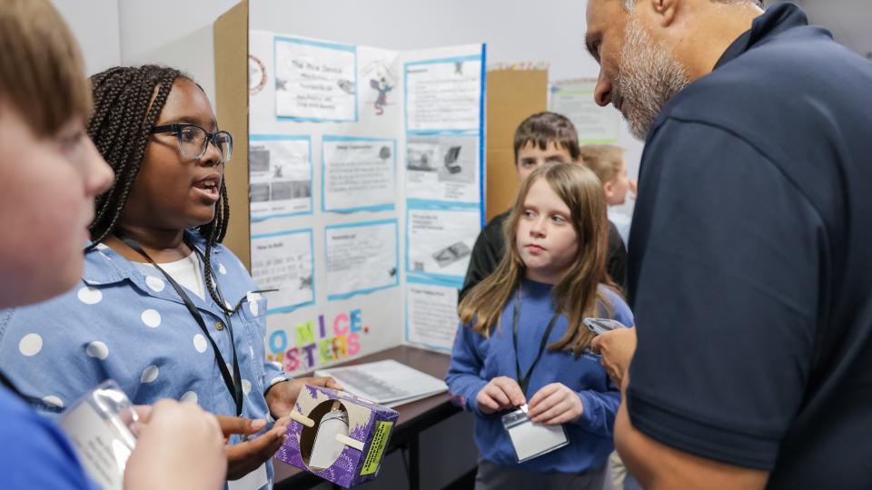 Students in Thomasville, Ga. explain their invention to a competition judge as a part of Georgia Tech’s expanding K-12 InVenture Prize program. 