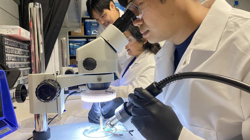Researchers in Hong Yeo's lab work on the electronics of wearable biosensors