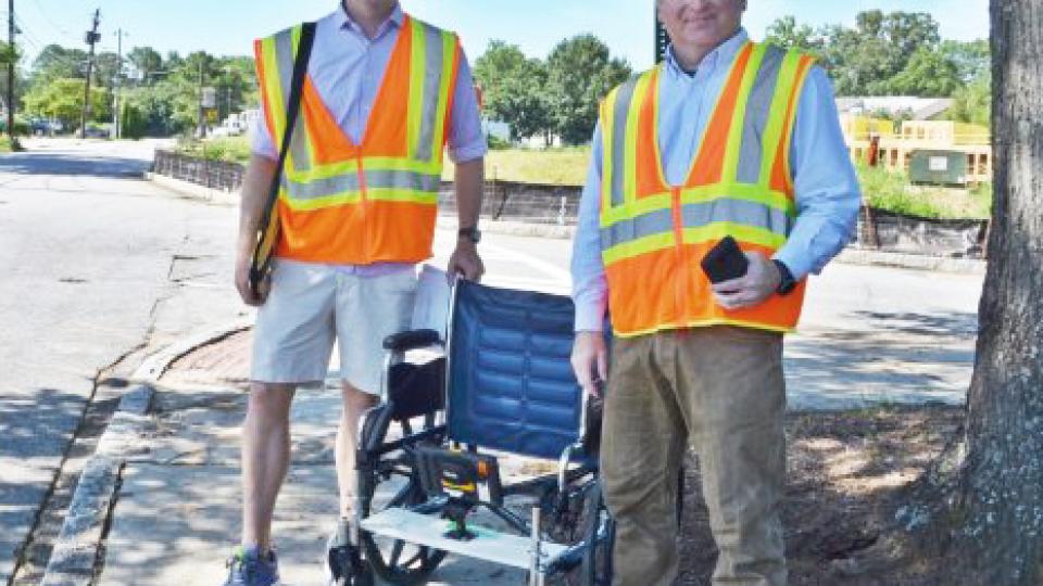 GT Professor Randal Guensler and grad student Daniel Walls demonstrating their wheelchair based sidewalk survey rig.