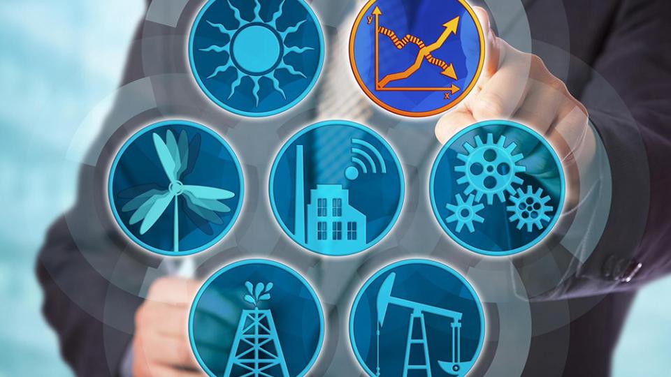 A stock image of a man manipulating symbols representing various forms of sustainable energy.