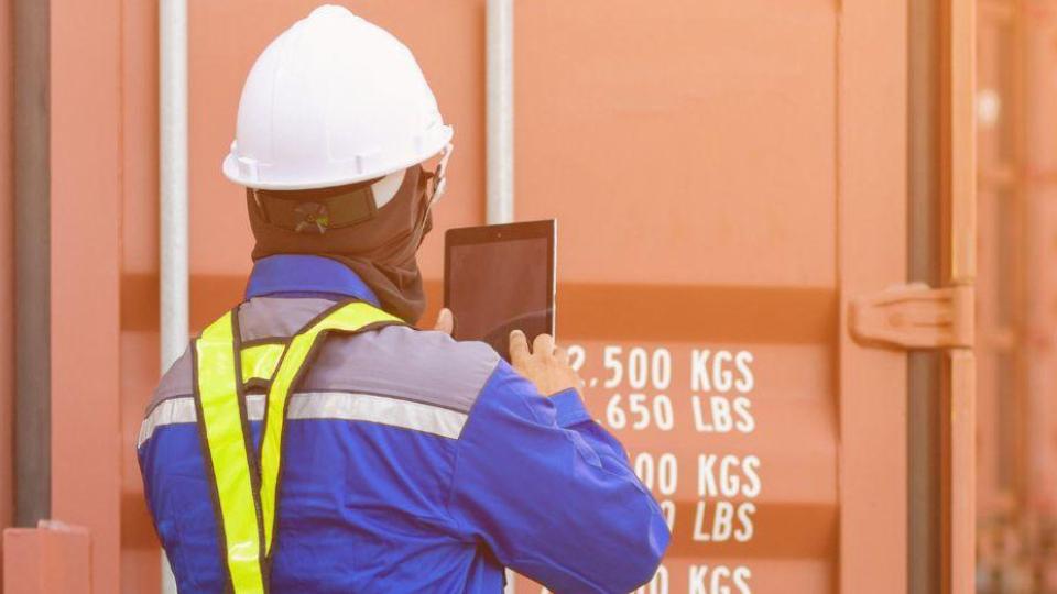 A Port of Savannah employee working with a shipping container