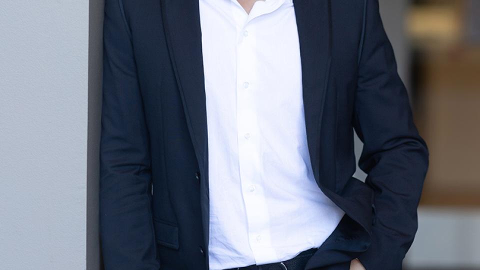 Gleb Yushin leaning on a wall. 