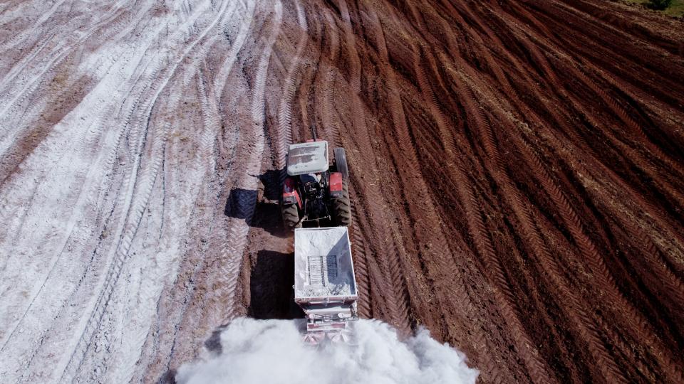 A tractor applying lime