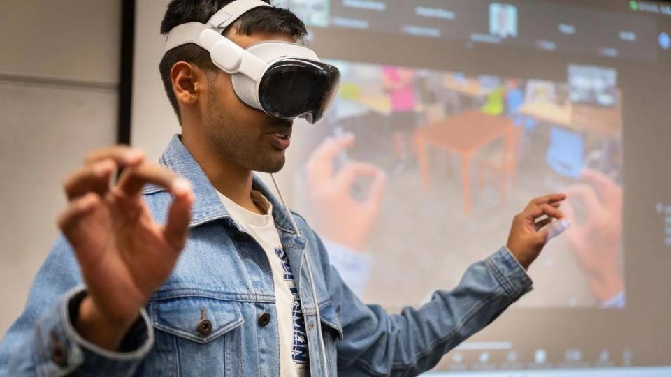 Georgia Tech student Yash Rajgure using an Apple Vision Pro headset device to demo his team's project.