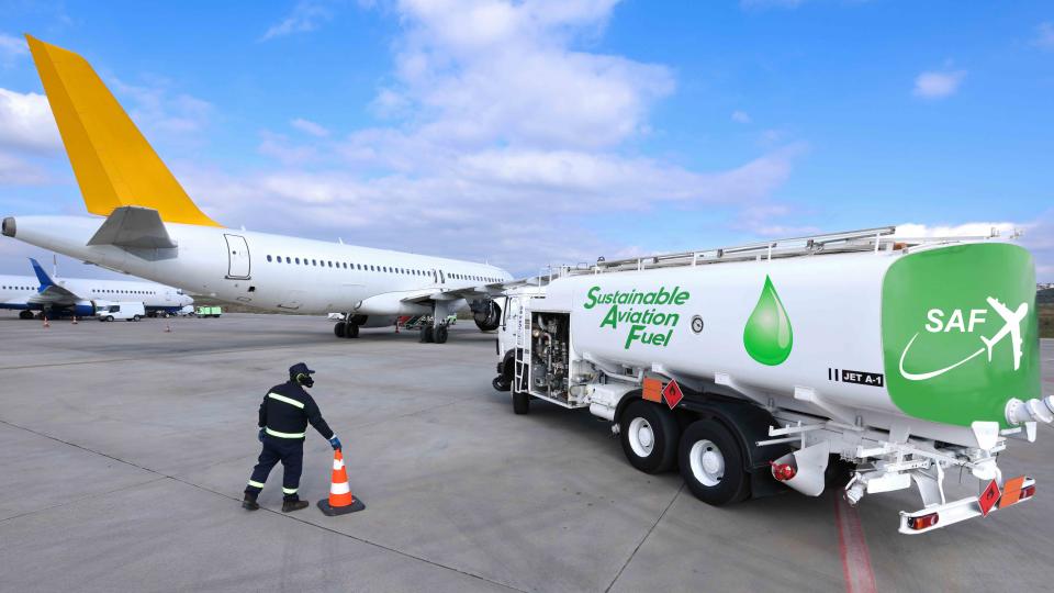 Fuel Truck carrying Sustainable Aviation Fuel near an airplane