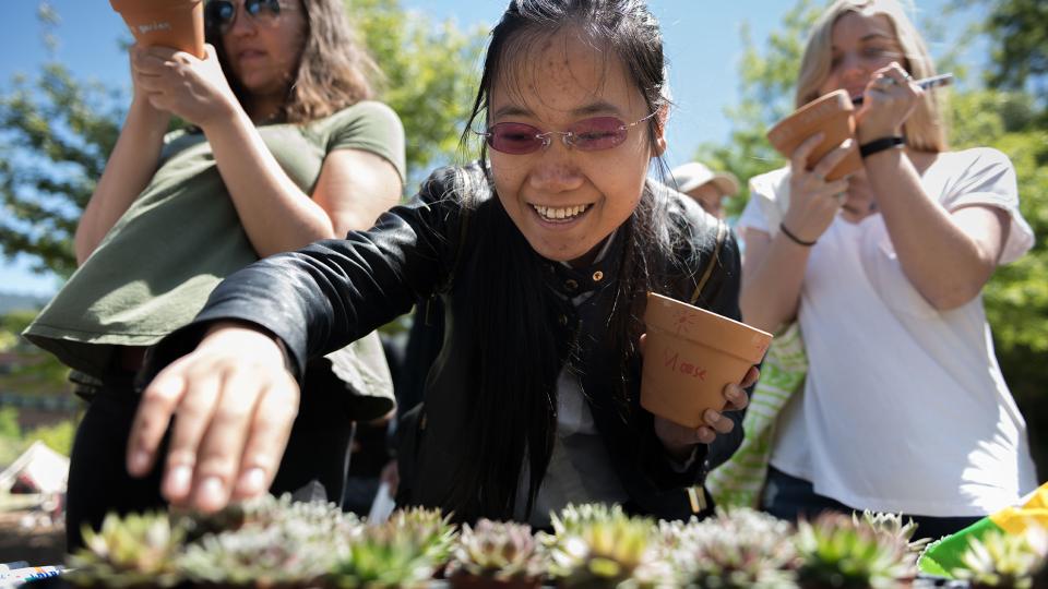 Students select succulents at a 2018 Earth Day event.
