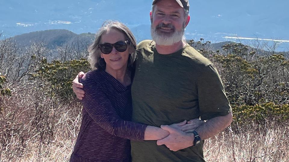 Rebecca Watts Hull and her husband Jonathan pose at a scenic overlook on a hiking trip.