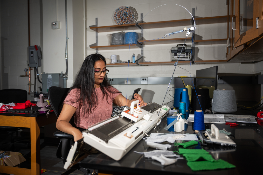 Krishma Singal operates knitting machine