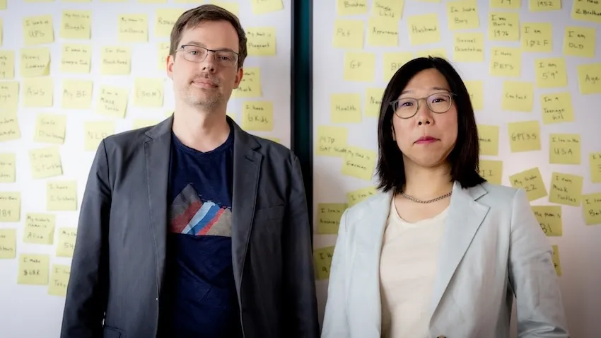 Alan Ritter and Wei Xu stand infront of a white board full of post-it notes