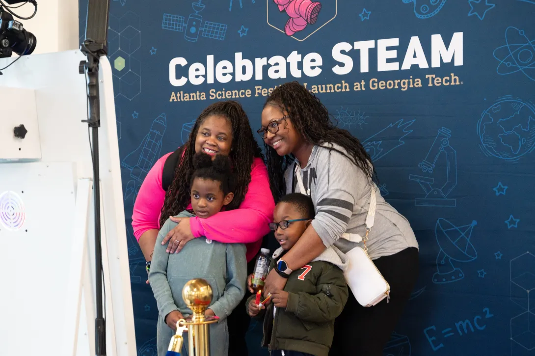 A family poses for a special moment in the Celebrate STEAM photo booth during Georgia Tech's Celebrate STEAM event on March 8.