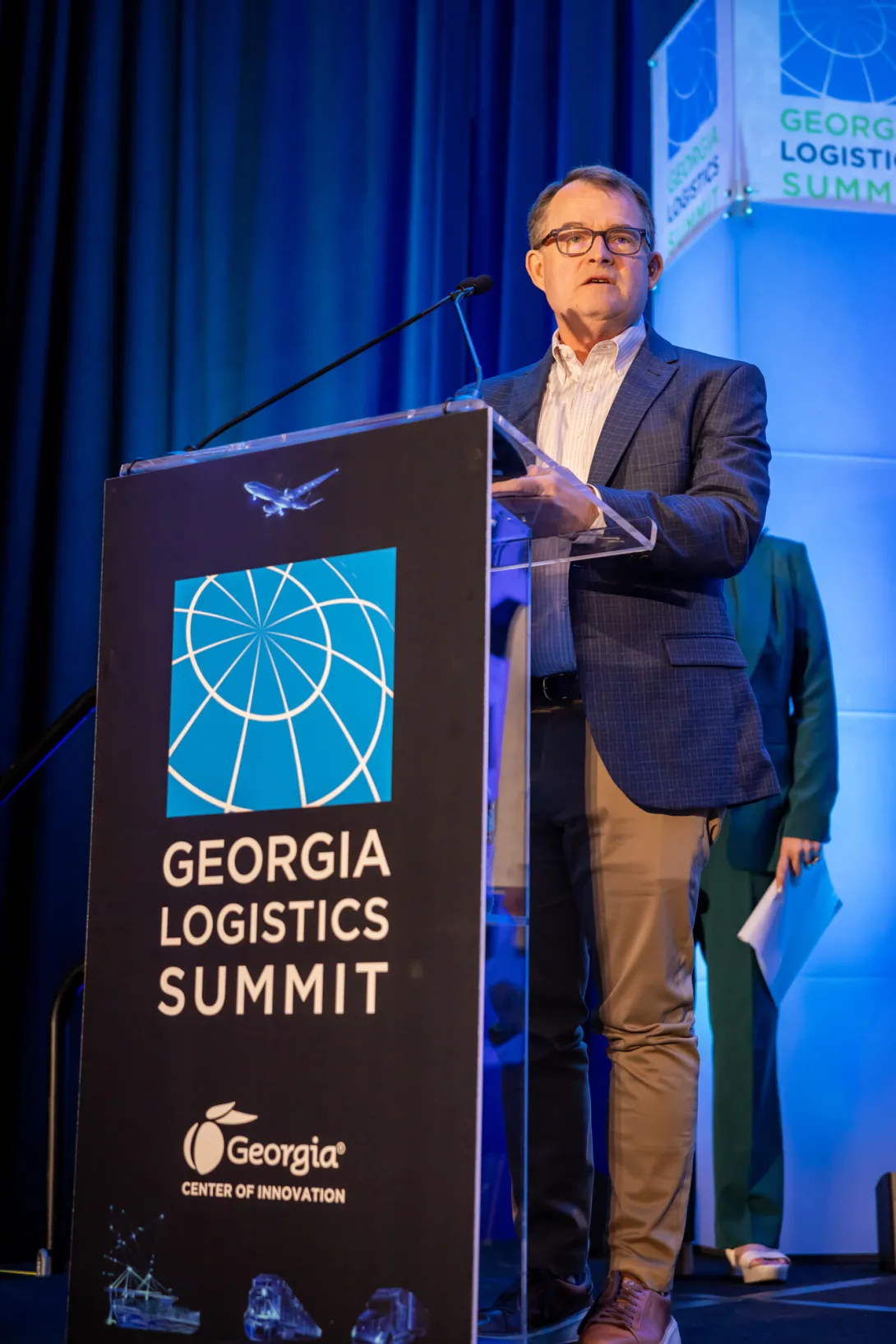 <p>Chris Gaffney of Georgia Tech’s Supply Chain and Logistics Institute addresses the Georgia Logistics Summit, reflecting on the power of public-private collaboration. “It’s that bridge between dialogue and execution that makes this group so valuable. Together, we’re building the capabilities that help Georgia’s communities and businesses grow, thrive, and lead.”</p> Chris Gaffney of Georgia Tech’s Supply Chain and Logistics Institute addresses the Georgia Logistics Summit, reflecting on the power of public-private collaboration. “It’s that bridge between dialogue and execution that makes this group so valuable. Together, we’re building the capabilities that help Georgia’s communities and businesses grow, thrive, and lead.”
