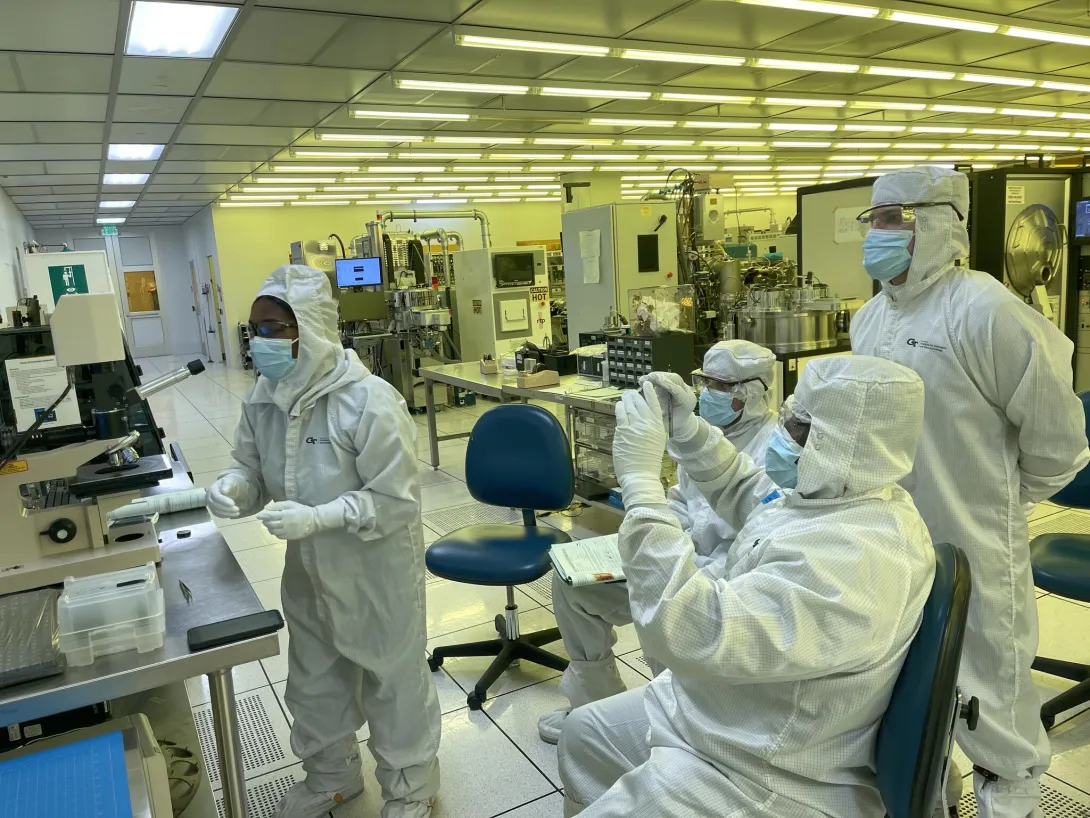 People in the cleanroom working on tools