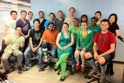 Group photo of BBISS students and staff wearing St. Patrick's Day regalia, mostly goofy socks.