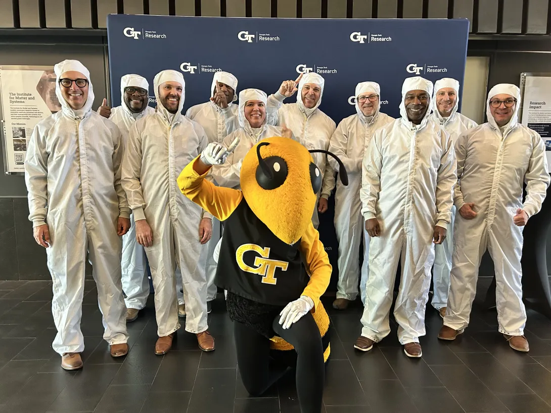 The IMS leadership team pose with Buzz at the Opening Showcase