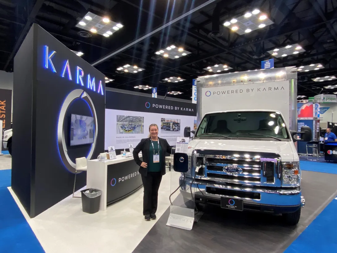 Jenn Voelker showcasing Karma's commerical product line at an auto show. 