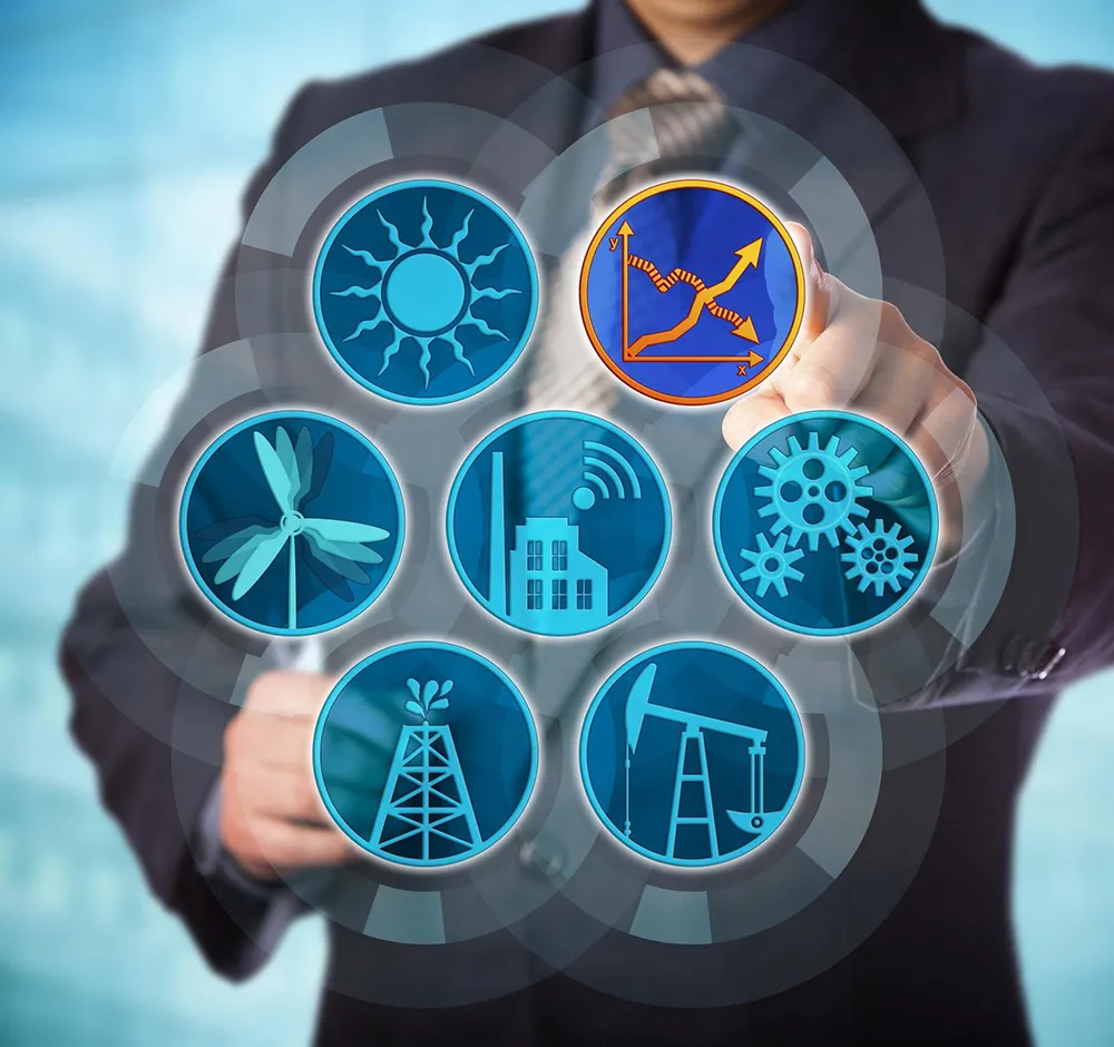 A stock image of a man manipulating symbols representing various forms of sustainable energy.