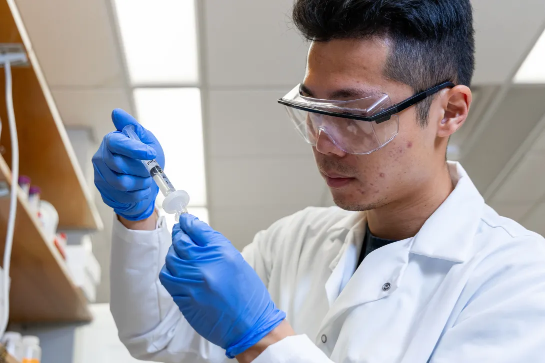 Student in the lab working with a sample