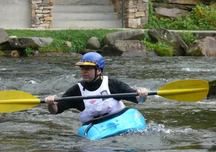 Rob Butera in a kayak white water rafting.